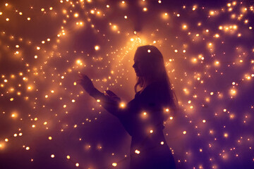 Silouette of a woman surrounded by lights