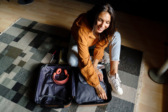 Female preparing suitcase 