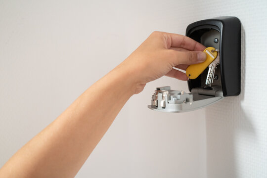 Hand Taking Key From Safety Box