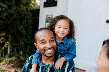 Sweet young girl leaning on dad's shoulders