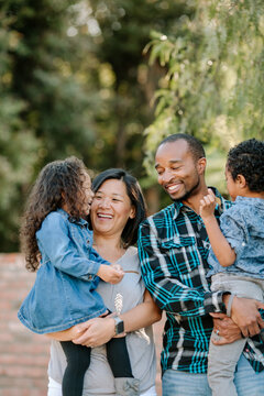 Laughing diverse family outdoors