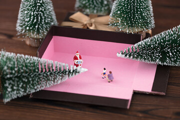 Unfolding the Santa Claus in the gift box to send gifts