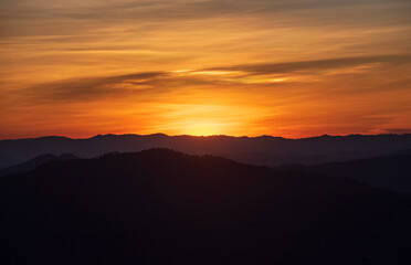 Fototapeta premium Colorful sunset over the mountain hills Thailand