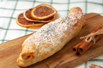 Traditional apple strudel on wooden board, close up