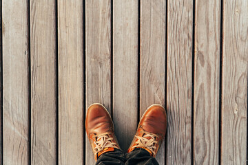 Feet on a wooden plank surface