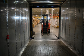 Man Loading tractor trailer truck at warehouse 