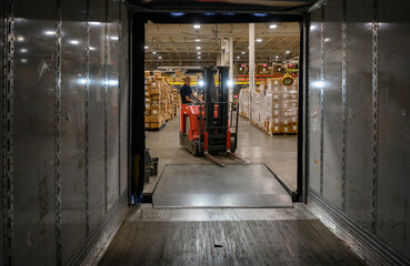 Loading dock and Forklift moving goods at warehouse