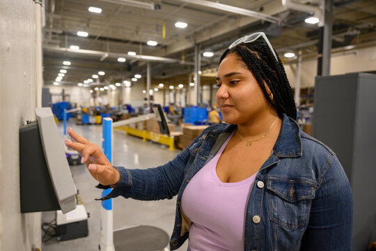 Employee checking in at work on electronic time clock