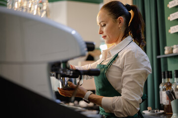 Caucasian female barista at work making coffee