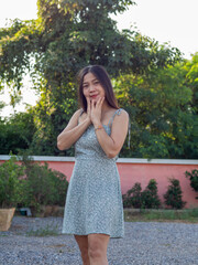 Naklejka premium a Asian nationality Thai woman wearing blue dress and feel good