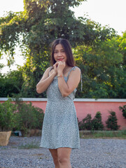 a Asian nationality Thai woman wearing blue dress and feel good