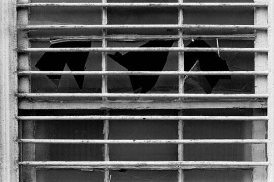 Barred window with broken panes
