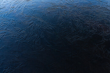 Blue ice shapes on a frozen pond