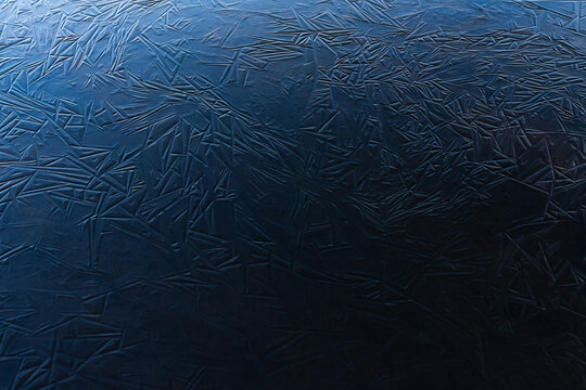 Blue ice shapes on a frozen pond