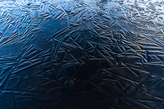 Blue ice shapes on a frozen pond