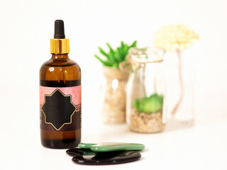 Beautiful bottle for cosmetics with decoration on a white background