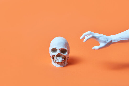 Hand reaching skull