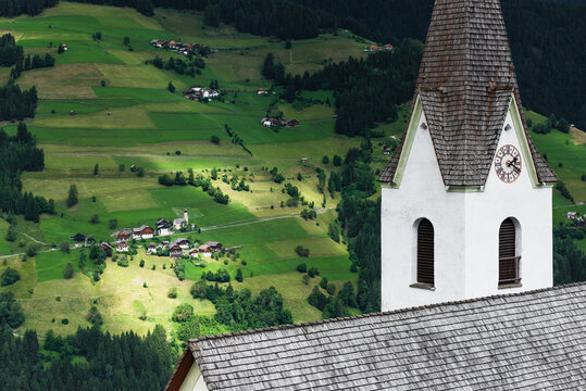 Tower of the church with village in the background