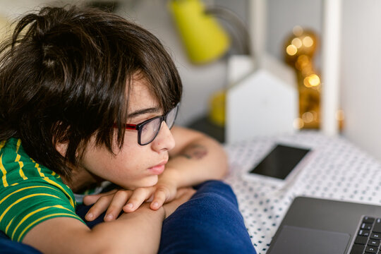 Boy on glasses watching movies comfortably 