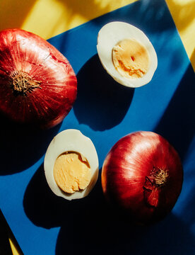 Still life boiled egg and red onion.