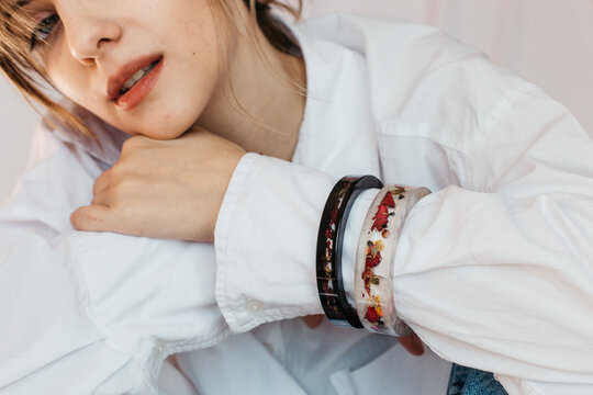 woman wearing two floral epoxy bracelets 