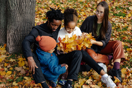Multiracial family spending weekend in autumn park