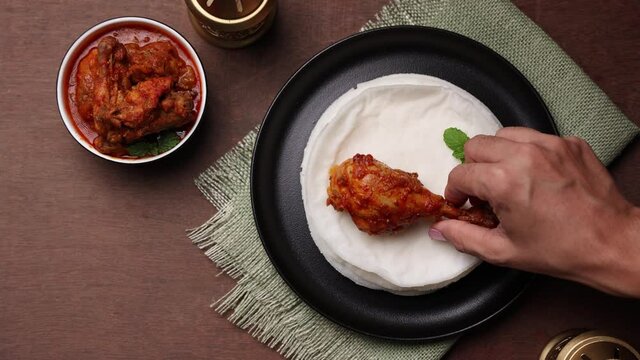 Rice Pathiri pathir flat bread spicy chicken curry woman hand serving traditional South Indian breakfast dish Rice roti 4K video footage Malabar Ramadan Ramzan, Eid festival Kerala India SriLanka