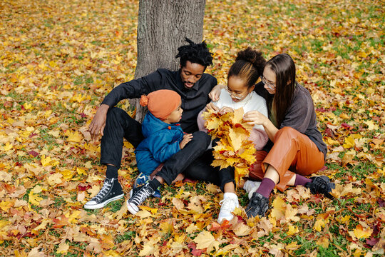 Diverse Family Enjoying Weather In Autumn Park