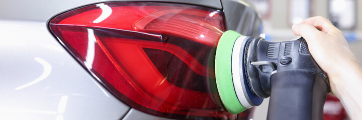 Detailing and polishing of car tail light on car closeup