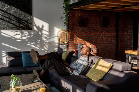 Man With Laptop On Couch