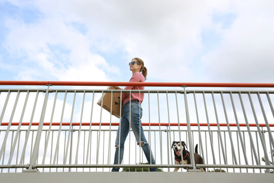 young woman with package on passageway