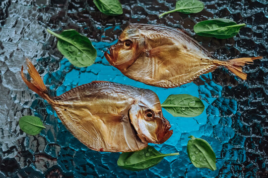 Salted dried fish on a glass plate.