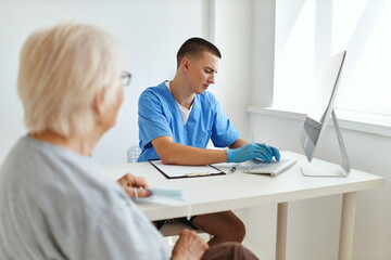 Fototapeta na wymiar elderly woman talking to a doctor diagnostics