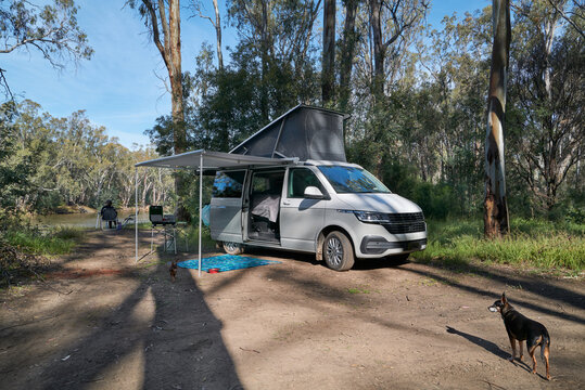 Campervan set up alongside river