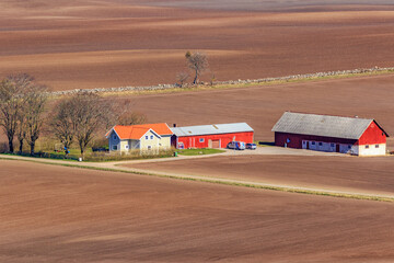 Farm in the countryside with newly sown fields