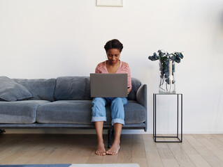 Beautiful african american woman shopping online from home