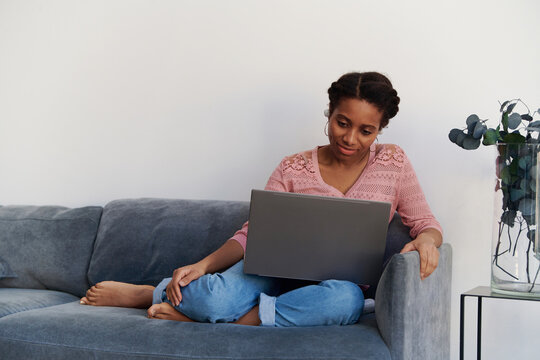 Portrait of a beautiful girl watching movie online at home