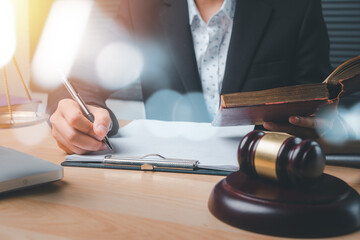 Male judge working with contract papers on white wooden table in courtroom. Laptop computer, legal...