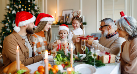 Happy big family with children exchanging gifts on Christmas morning at home