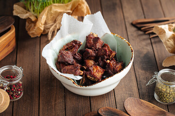 Bowl of small lamb ribs appetizer on wooden background