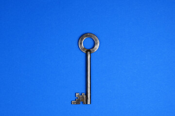 Old metallic keys isolated on blue background. Flat lay.