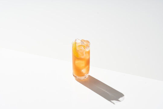 Glass of cold cocktail with ice