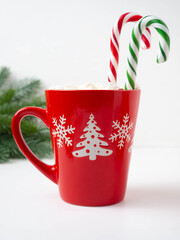 Red mug with hot chocolate with marshmallows.