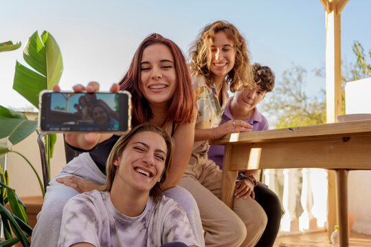 Teen friends taking selfies outdoors