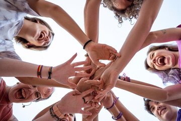 Low angle friends joining hands