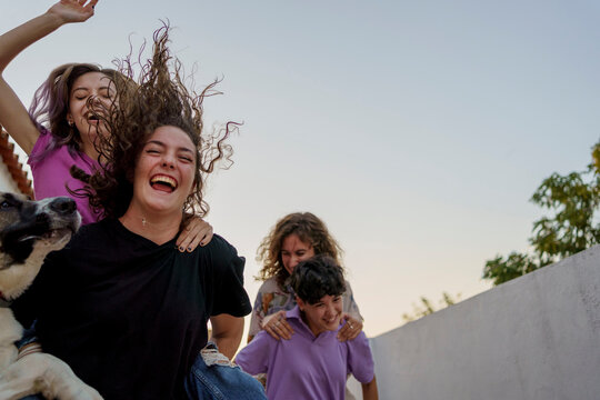 Funny teens playing outdoors
