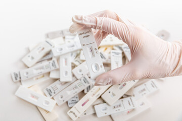 Pile of Covid Rapid antigen tests on white background