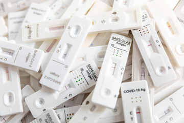 Pile of Covid Rapid antigen tests on white background - obrazy, fototapety, plakaty
