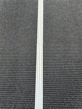 rug with with linear aluminium strip