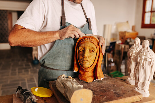 Artisan working with clay in workshop
